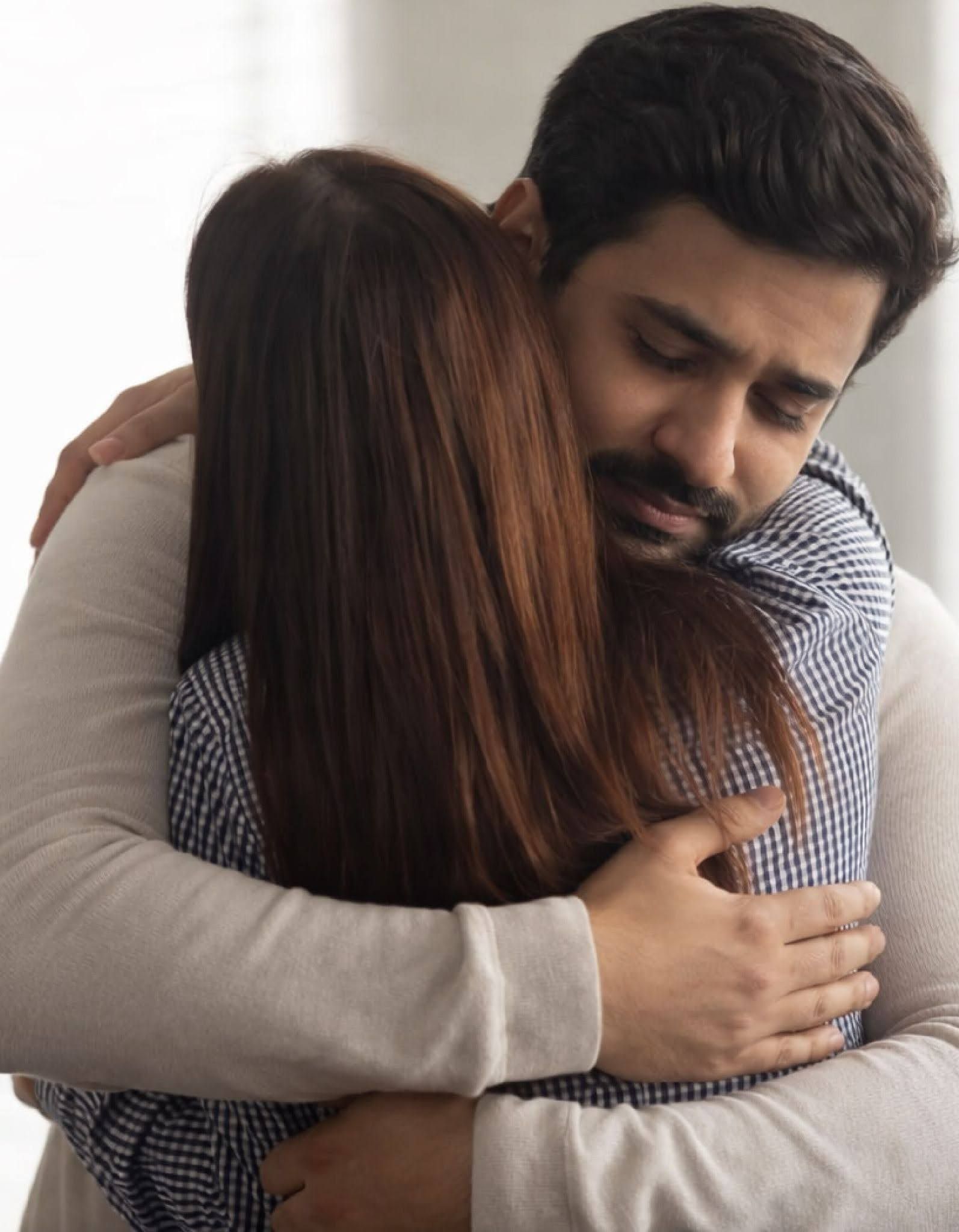An adult couple embracing closely, showing emotional reassurance linked to separation anxiety disorder in adults.