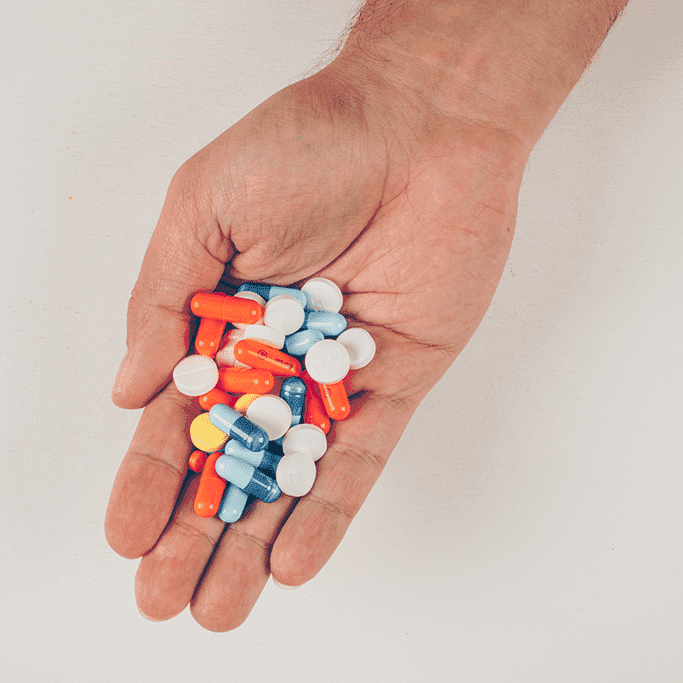 A person holding drugs and pills