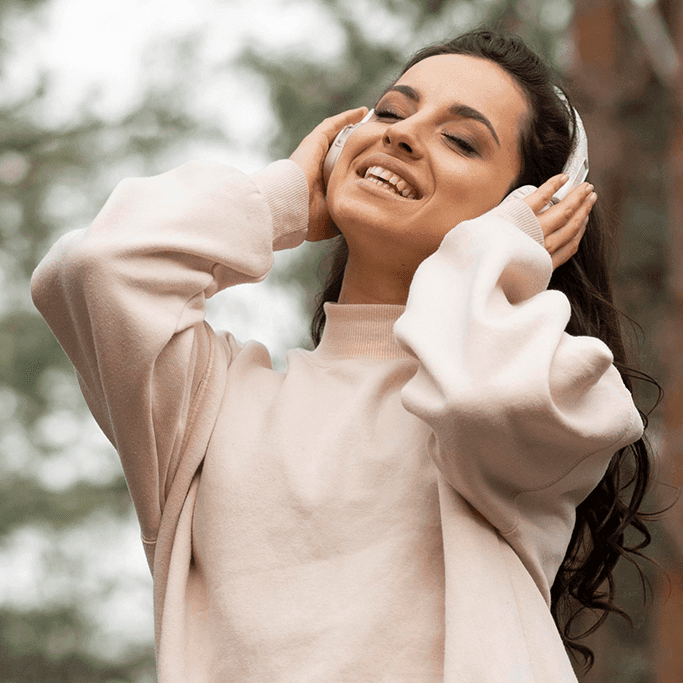A woman enjoys music with her eyes closed, showing peace and emotional release. This moment reflects psychological facts about how music influences mood, reduces stress, and supports mental well-being.