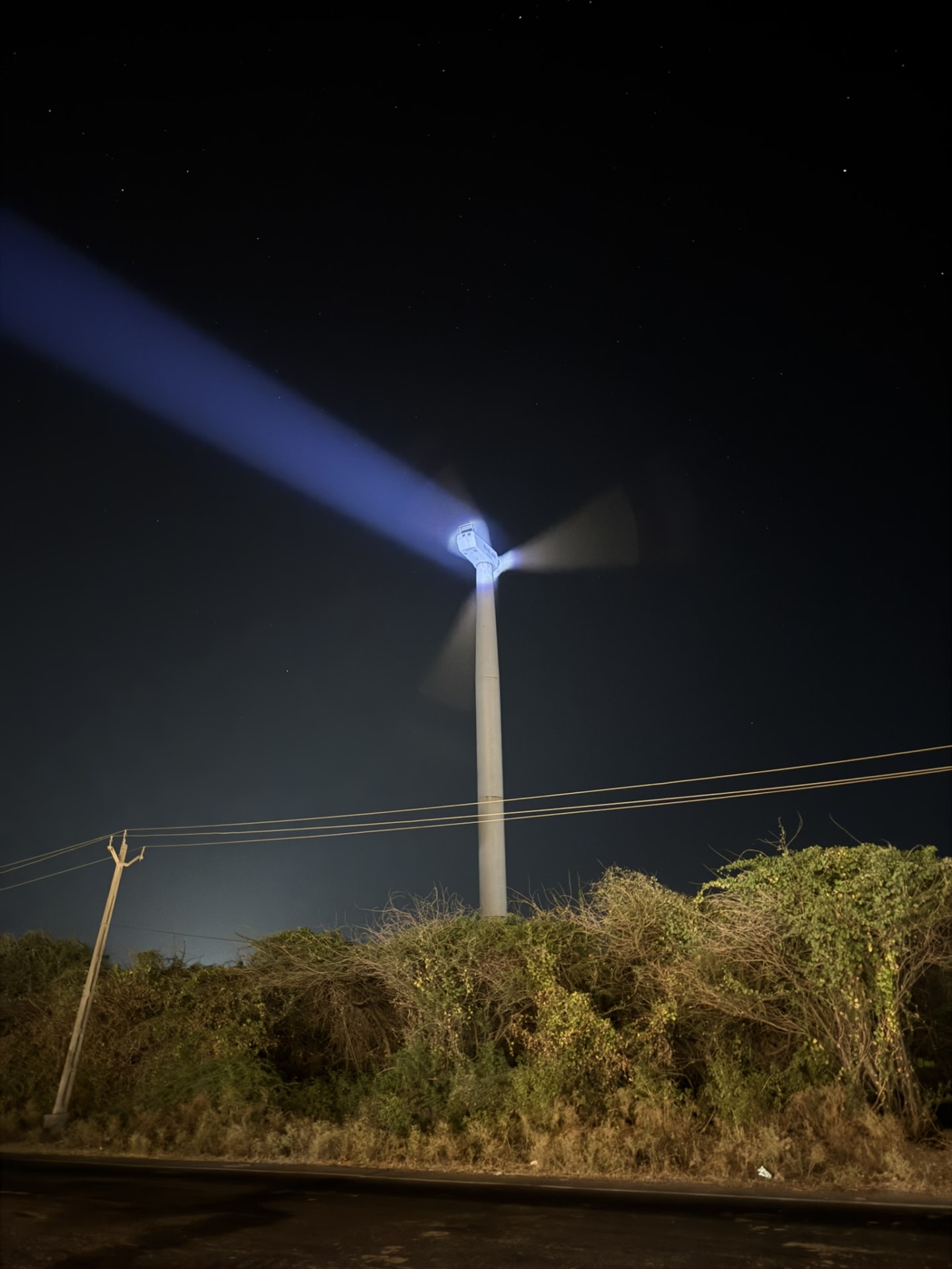 The high beam light pointed at a nearby windmill