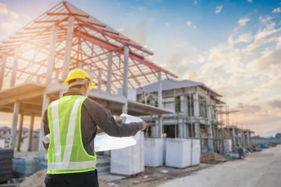 Photo of builder looking at plans