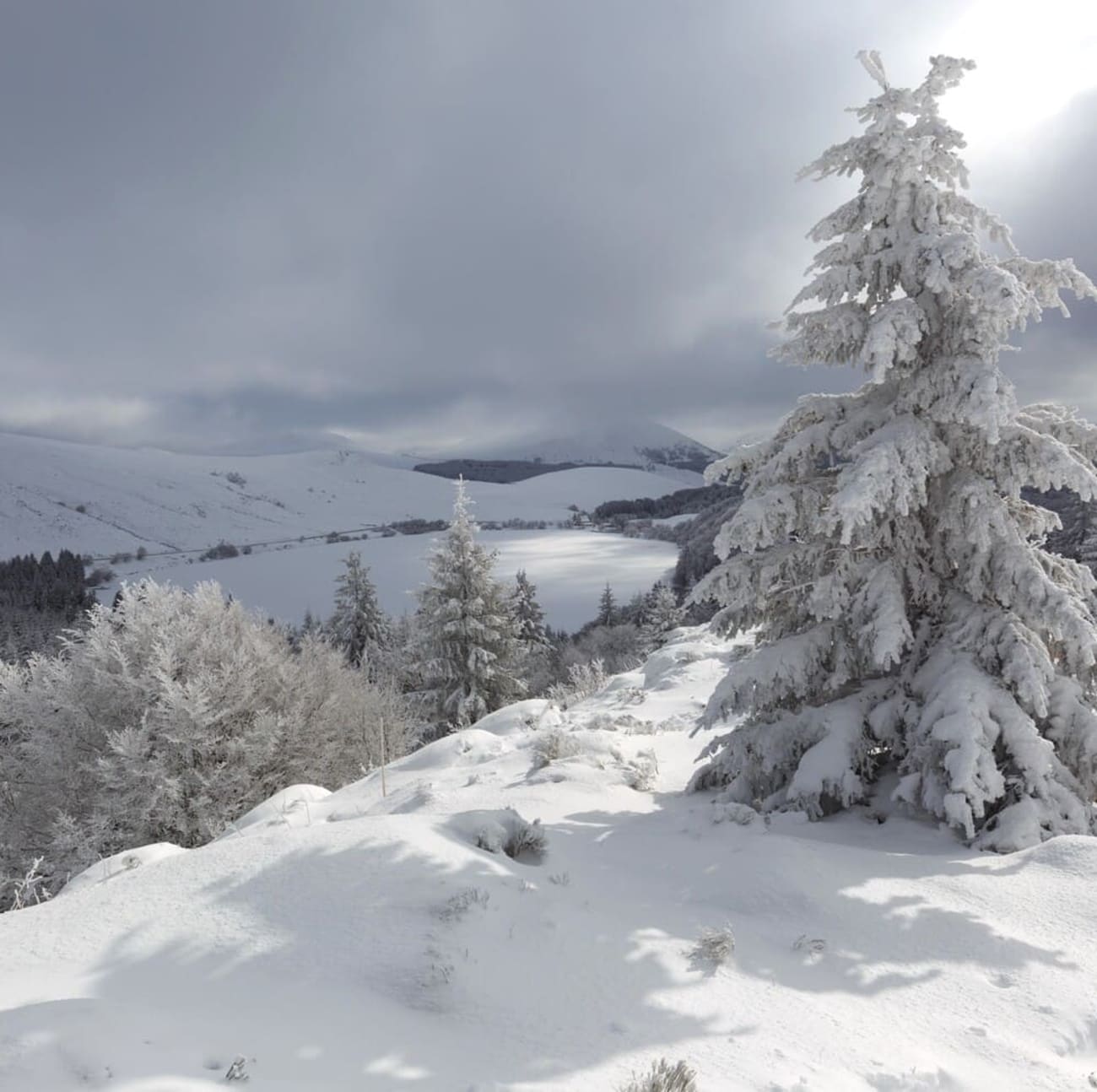 Randonnée raquettes auvergne : vue sur le lac de Guéry et paysage enneigé depuis les hauteurs environnantes