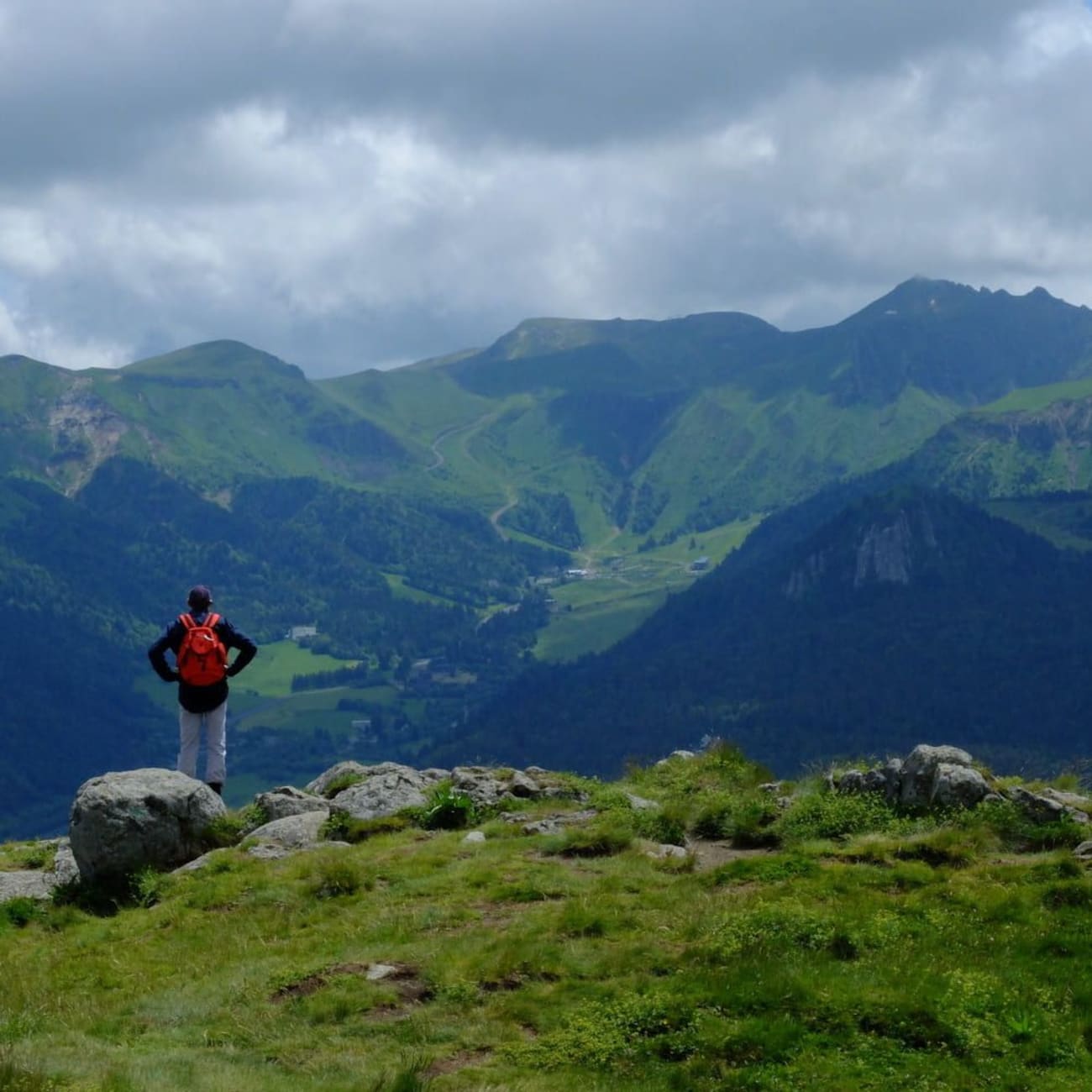 Randonnée banne d'Ordanche : homme de dos sur montagne contemplant les sommets verdoyants