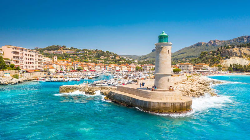 Randonnée calanque de Port-Pin : côte avec maisons, bateaux, phare et eau turquoise