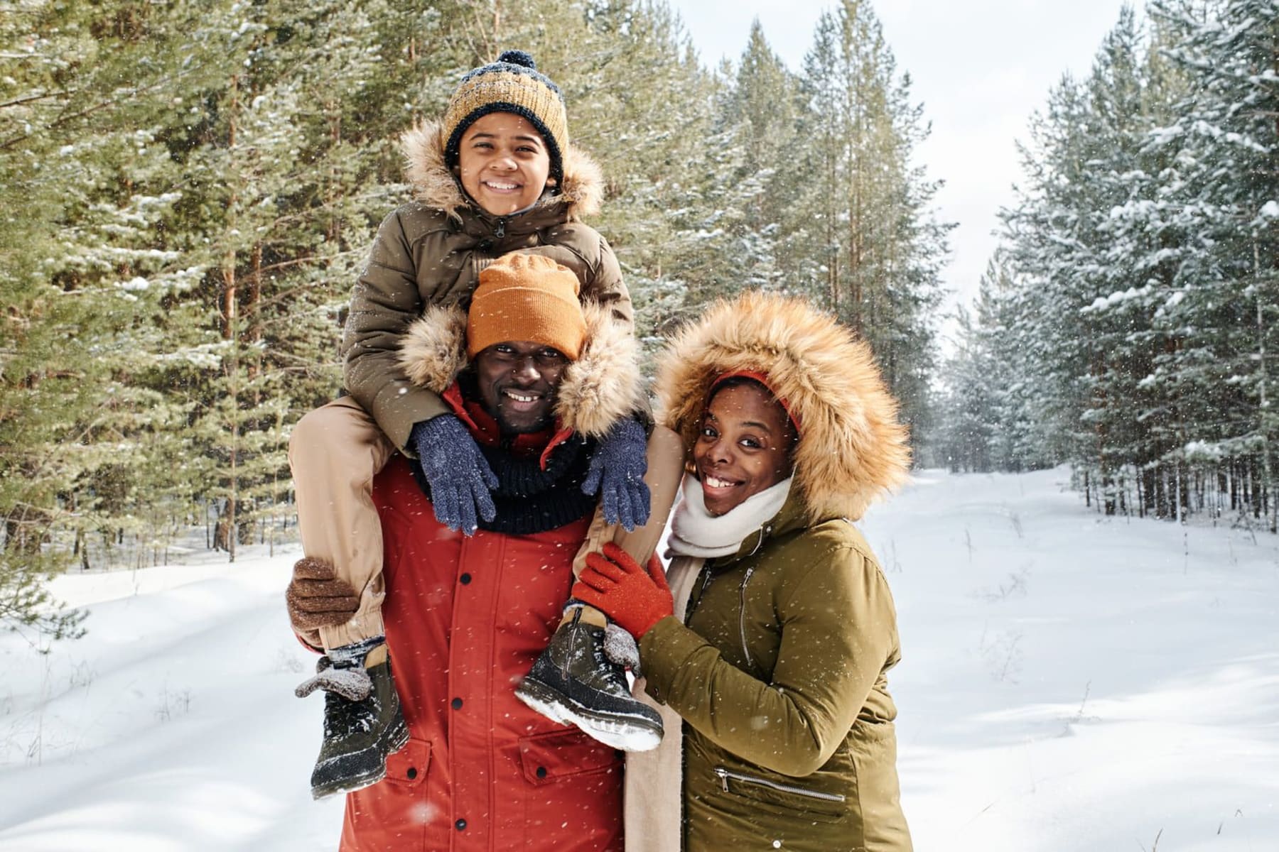 Famille en montagne dans une forêt enneigée