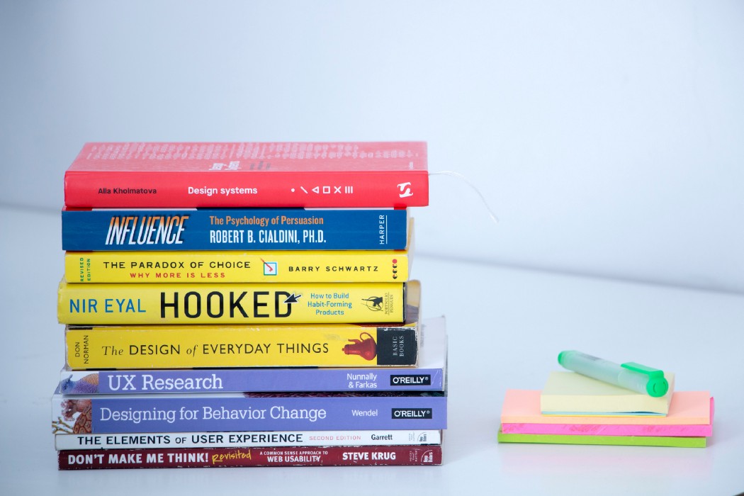 Stack of books next to post-its