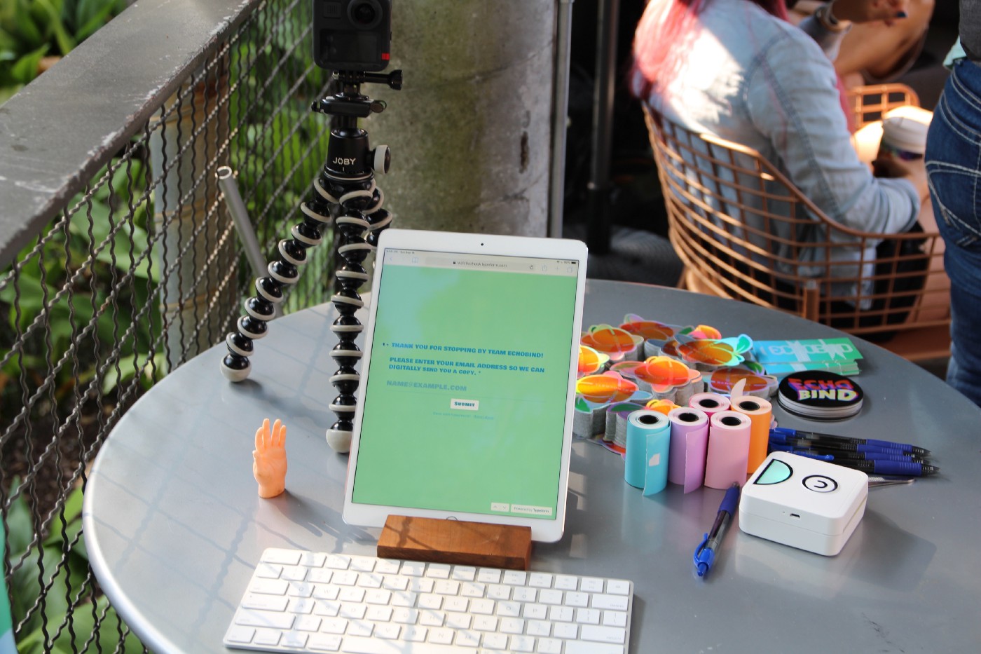 Echobind’s booth talel setup with ipad, keyword, and printer.