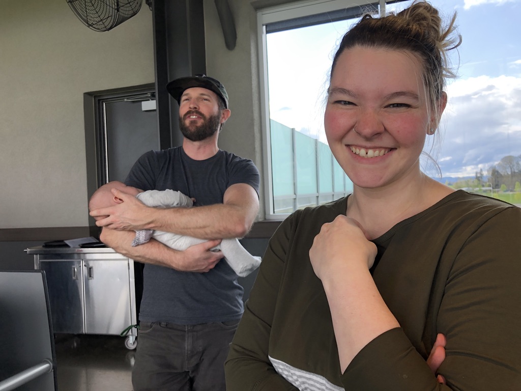Woman smiling and man holding baby