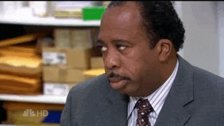 Character from The Office show rolling his eyes gif