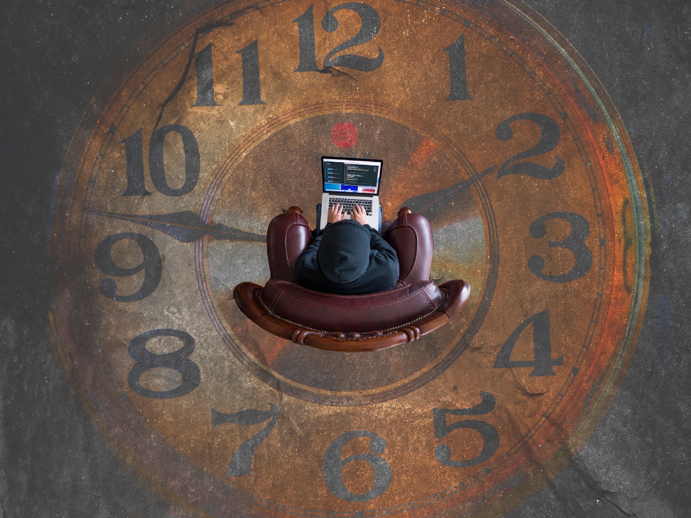 Person sitting with laptop in the middle of a clock painting