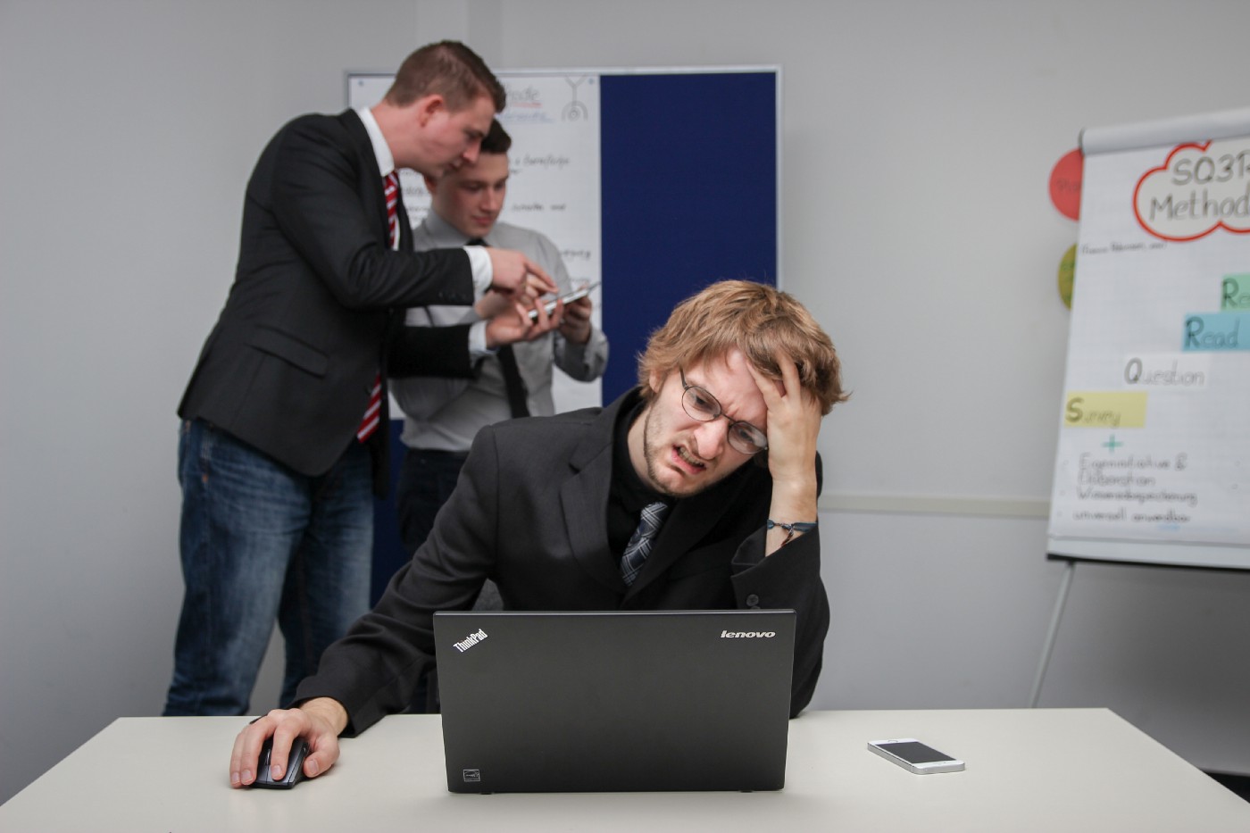 Three men discussing user design