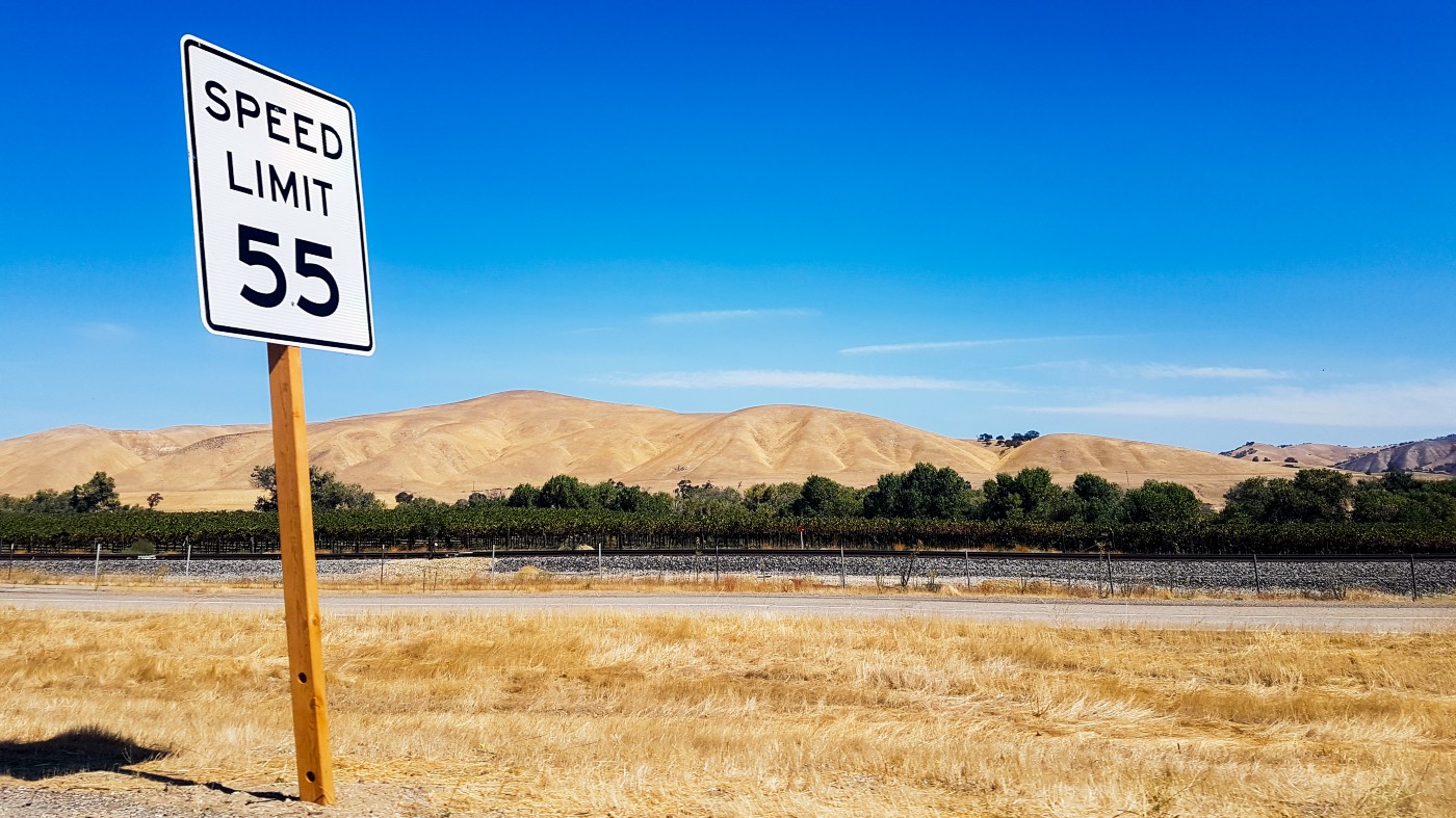 Speed limit 55 sign on a highway