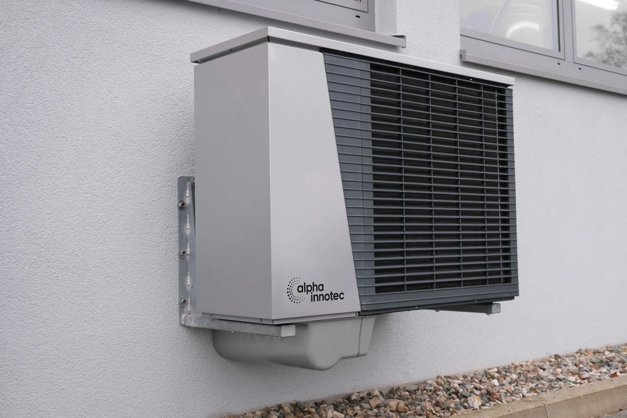 A heat pump unit beside a house