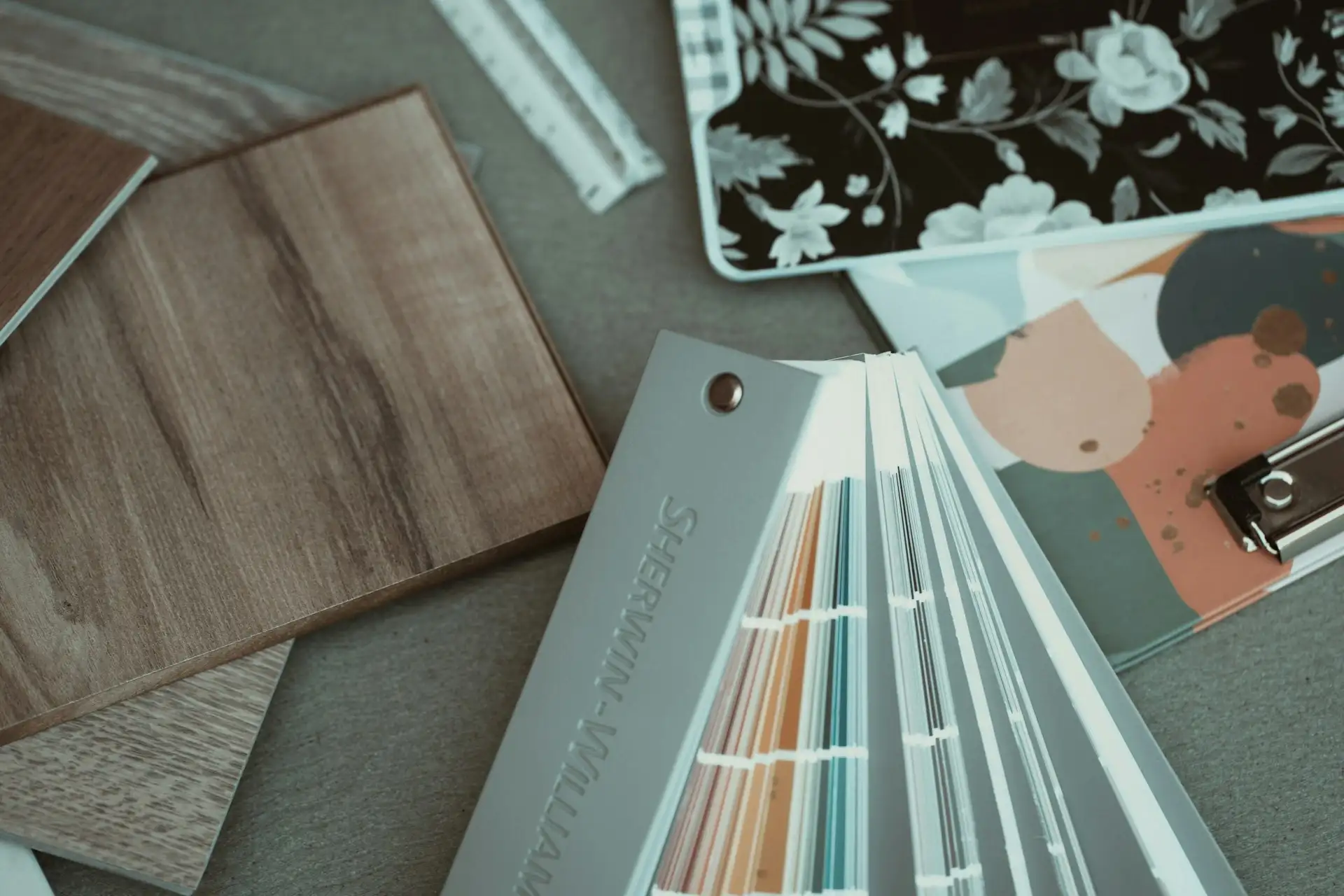 Samples of hardwood, engineered, and vinyl plank flooring on a table