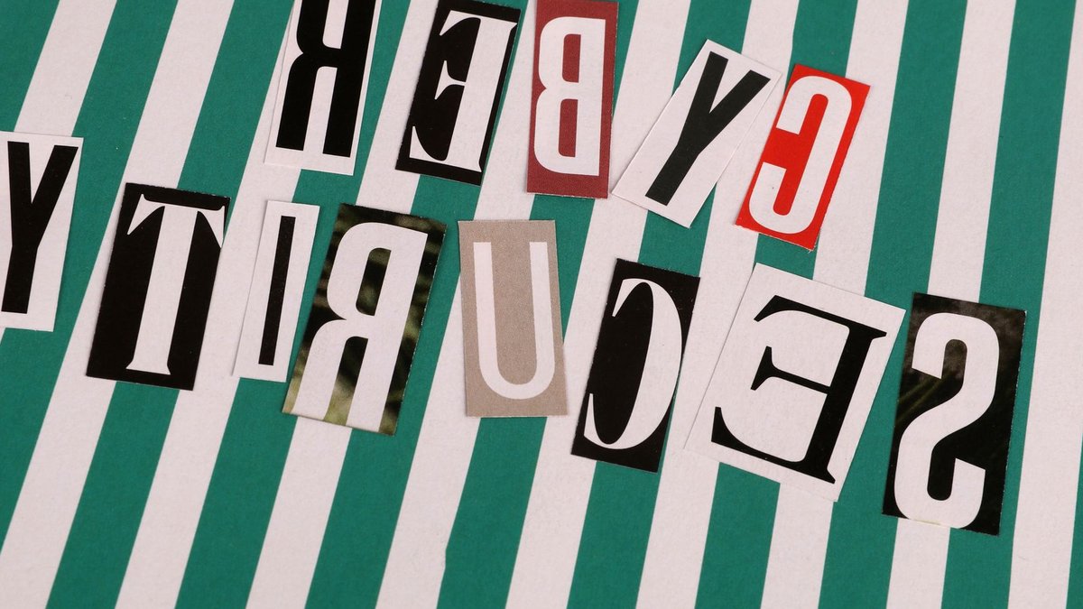 Cyber security concept depicted with a creative text collage on striped background.