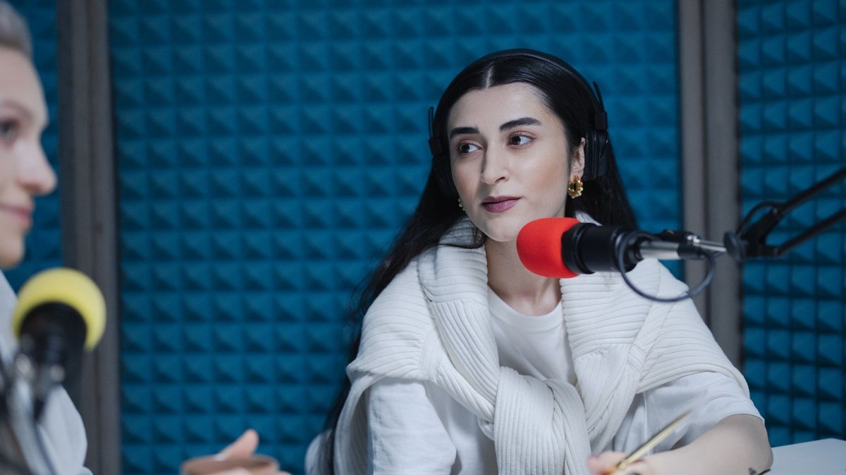 bunq chief evangelist touts AI-driven banking future Two women engaged in a podcast recording with professional microphones, soundproof studio.