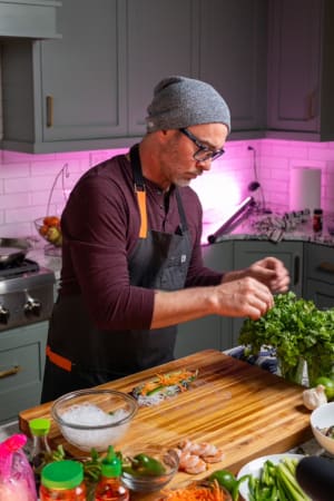 Chef Justin preparing asian cuisine using fresh ingredients