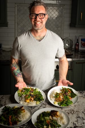 Chef Justin plating private dining dishes with vibrant colors