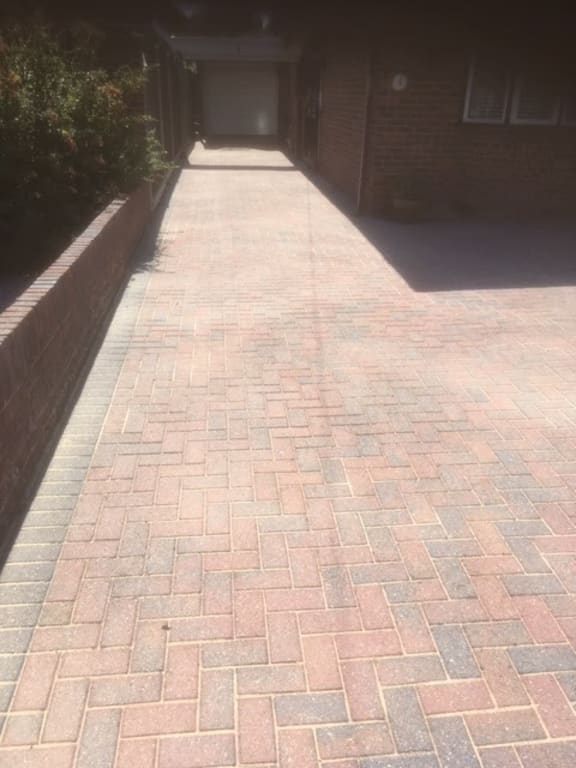 Clean and completely restored brick paving after professional pressure washing