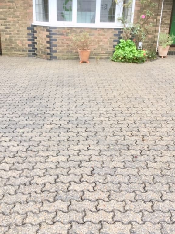 Brightened stone patio flagstones completely clean following deep pressure cleaning