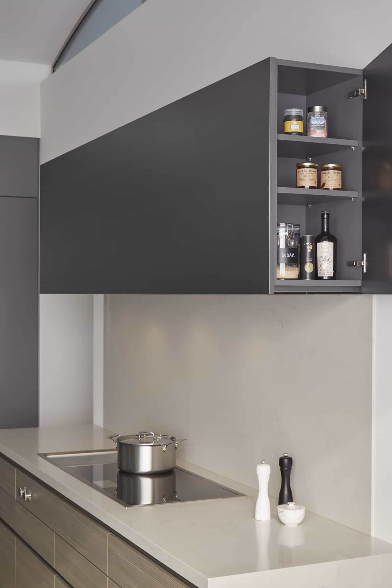 A surprise endcap cabinet in the main kitchen flanking the stove hood with Miele insert