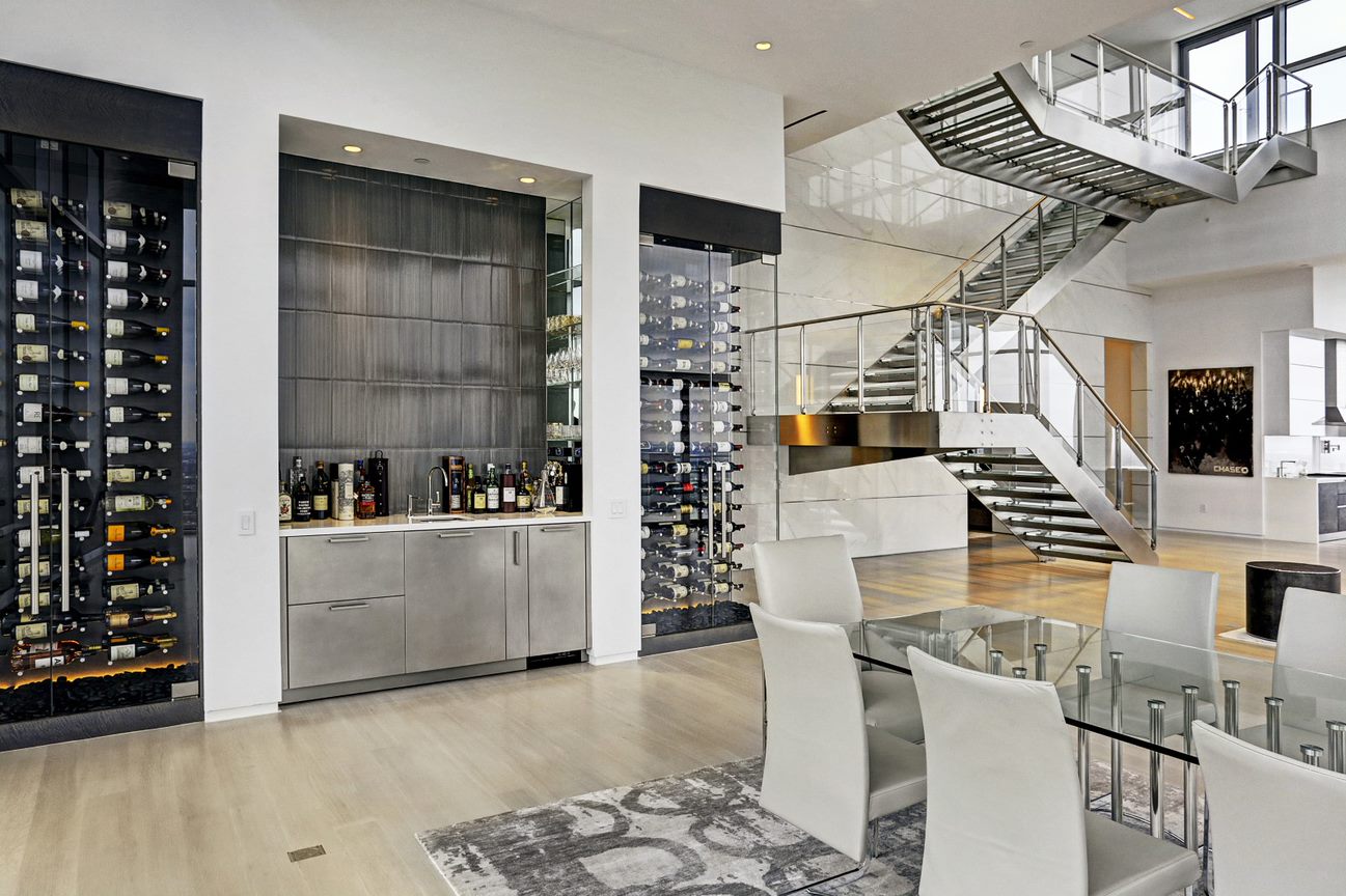 dining room and elaborate high end bar and wine rooms of the east penthouse in the 2727 kirby luxury high rise condos in houston
