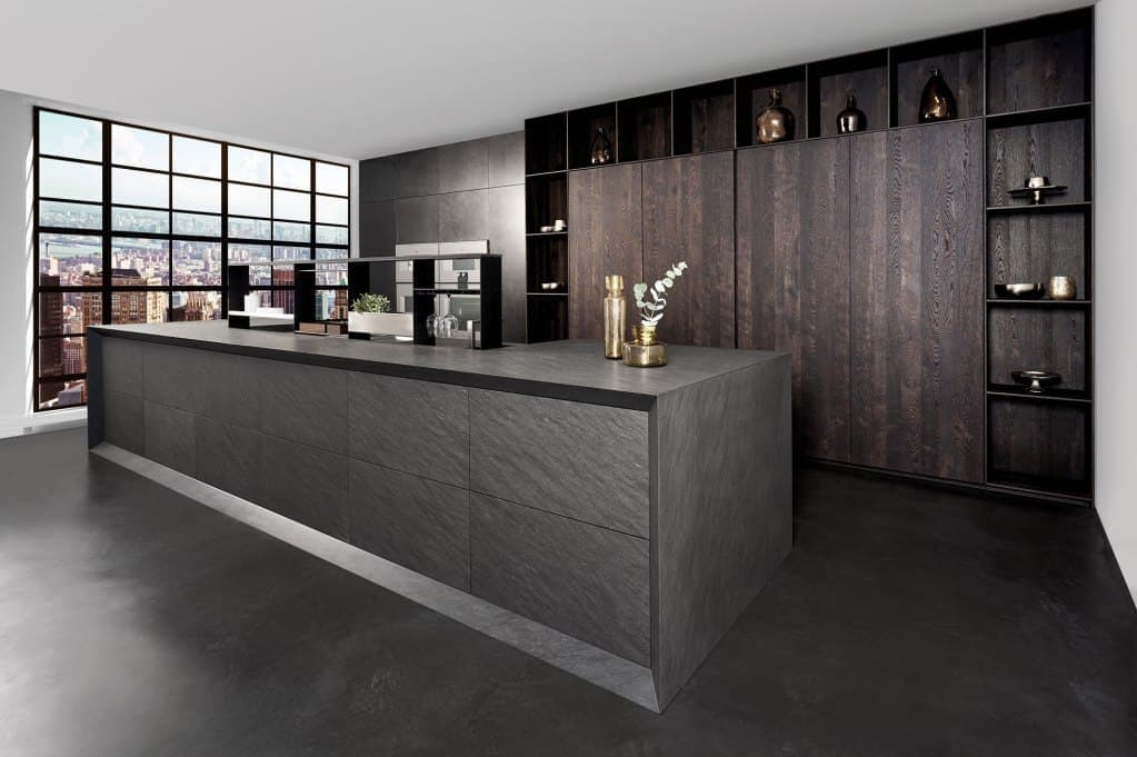 stone kitchen island with FRAME7 deep mitered edges and tall wall cabinetry in dark wood veneers