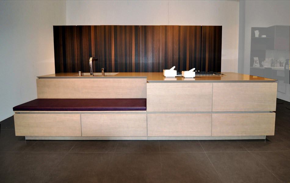 sandlbasted and smoked oak cabinetry with built-in upholstered bench featured in the eggersmann florida german kitchen showroom