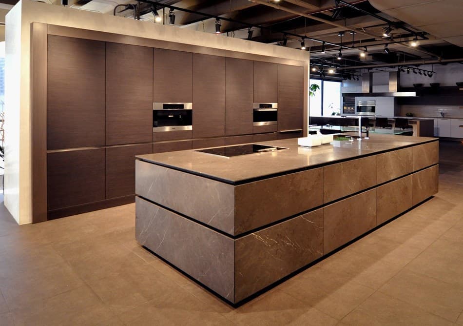 modern kitchen featuring a graphite brown limestone stone island designed using eggersmann's unique collection