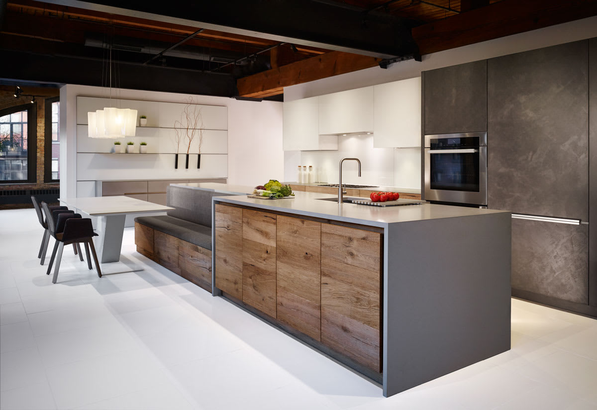 kitchen island with builtin banquette bench featureing Chablis Vintage Oak, Tokyo Vetro White Glass, and Dark Grey Concrete finishes