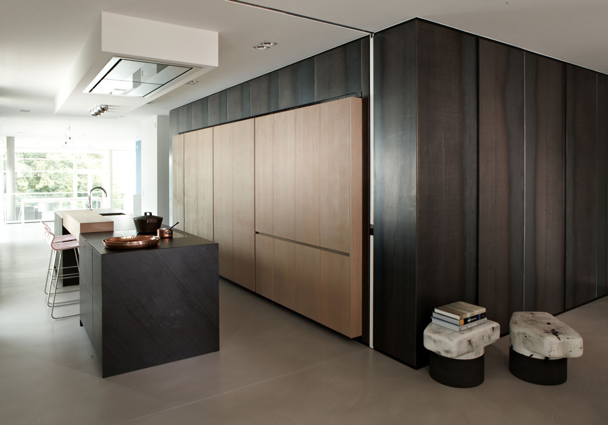 unique collection of cabinetry in Phyllite Black Leather Quartz and Vancouver Oak Sandblasted finishesby eggersmann used to create a desk in a minimalistic office