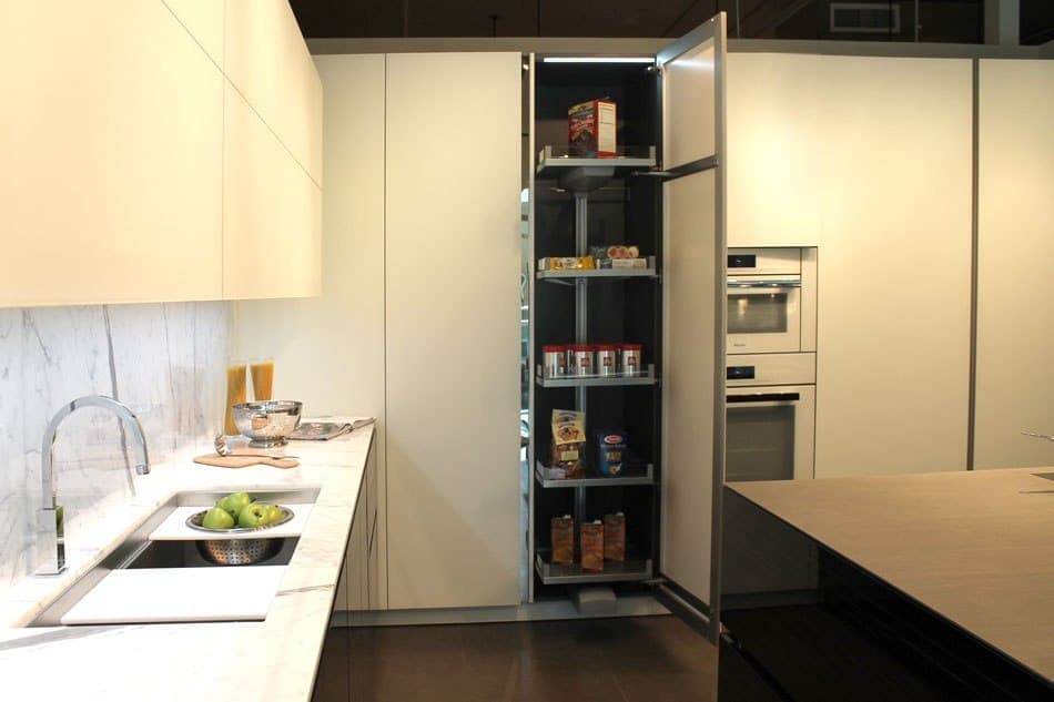 sleek modern black and white kitchen features a generous hideaway pantry