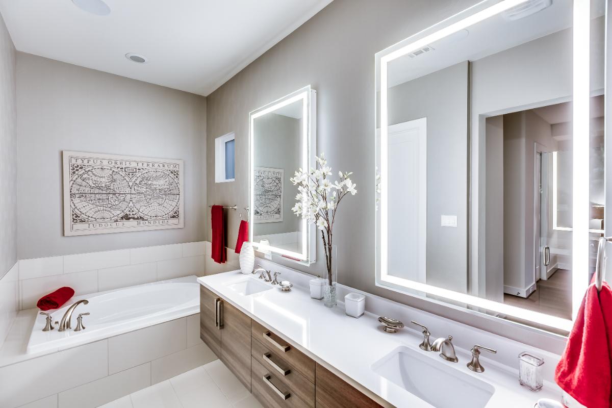 eggersmann-designed luxury bath featuring wood veneer cabinetry fronts and a garden bath tub in a home in royal oaks courtyard villas in houston