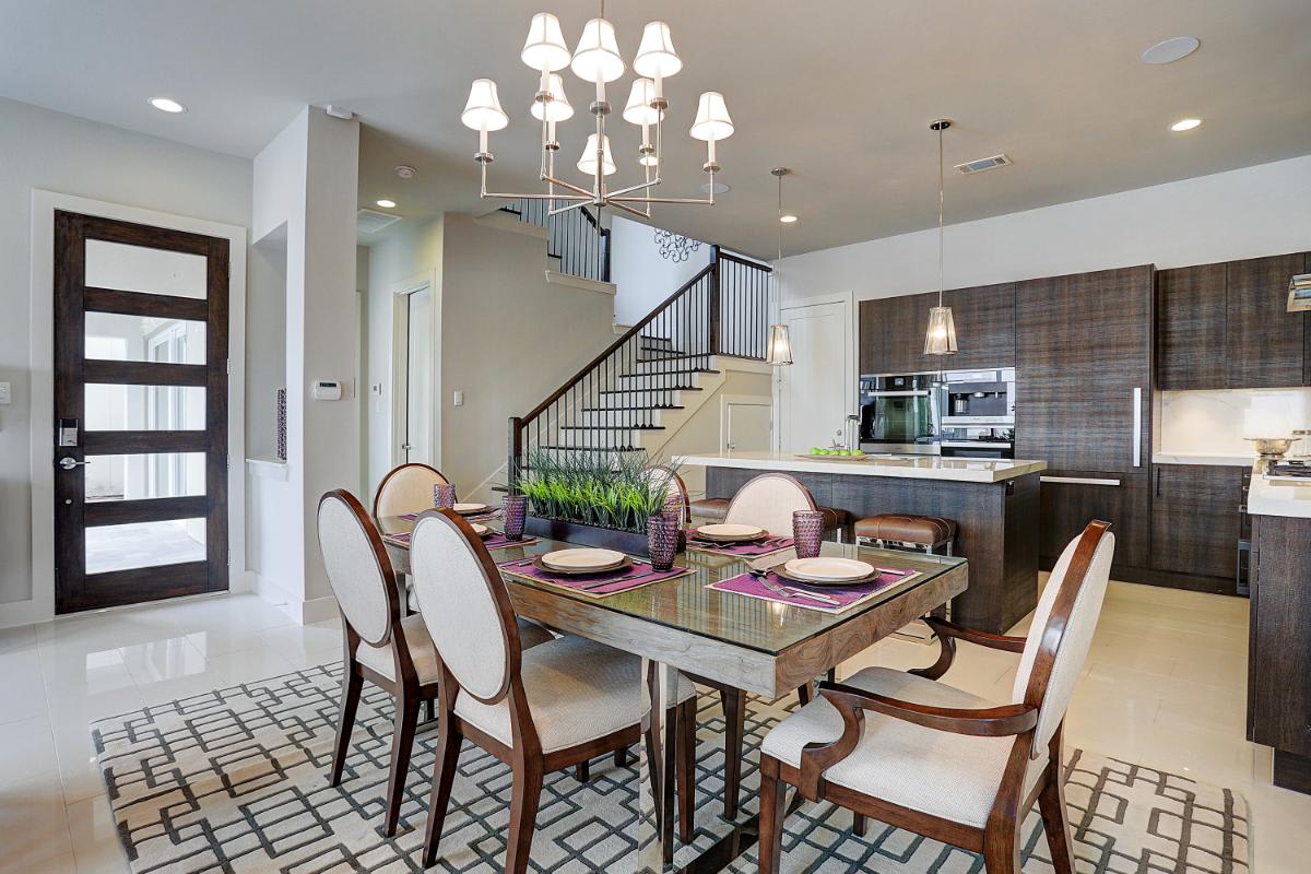 dining area of an eggersmann-designed kitchen featuring cabinetry in a grain-matched dark wood veneer in a home in royal oaks courtyard villas in houston