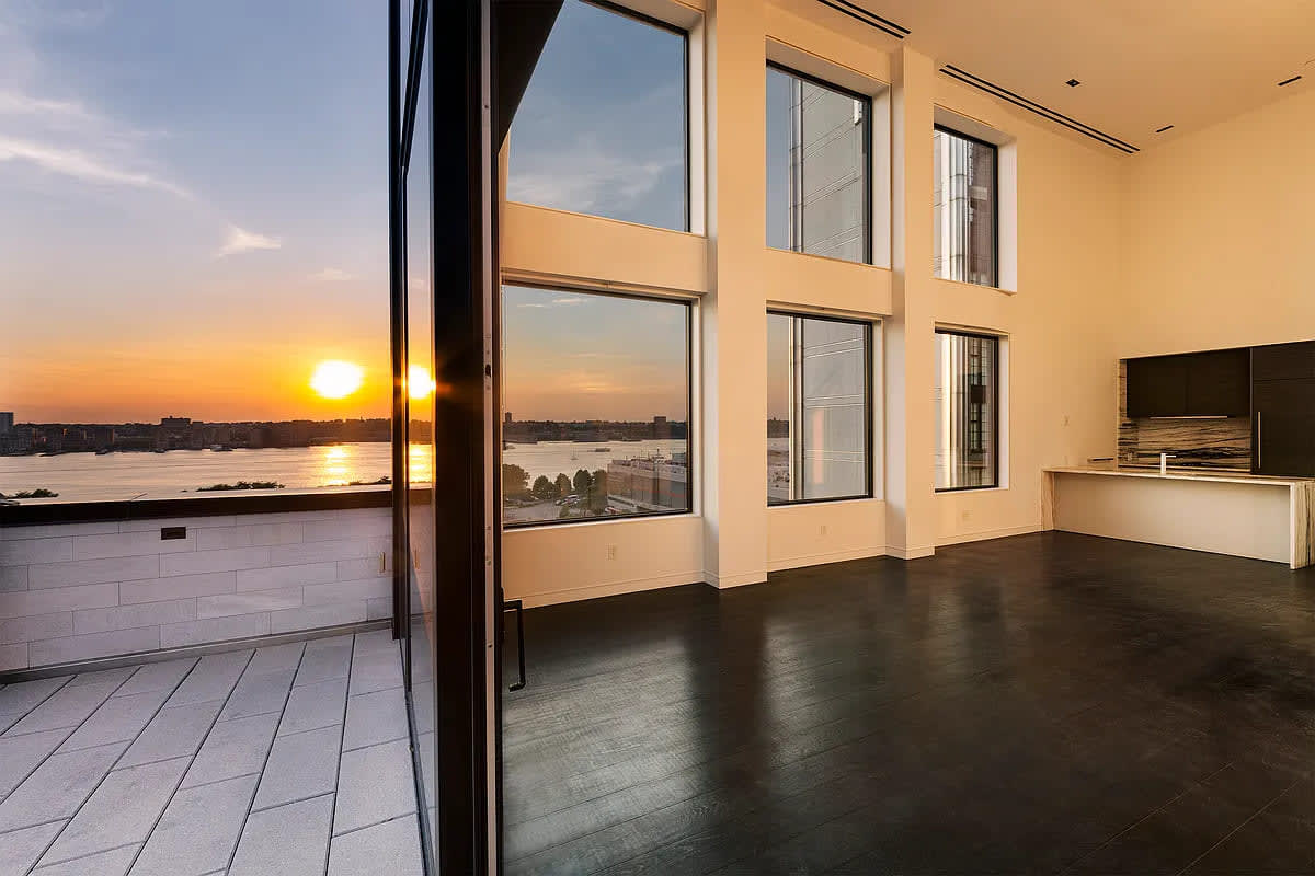 indoor/outdoor living with wide opening from balcony to interior in a residence of chelsea waterside nyc
