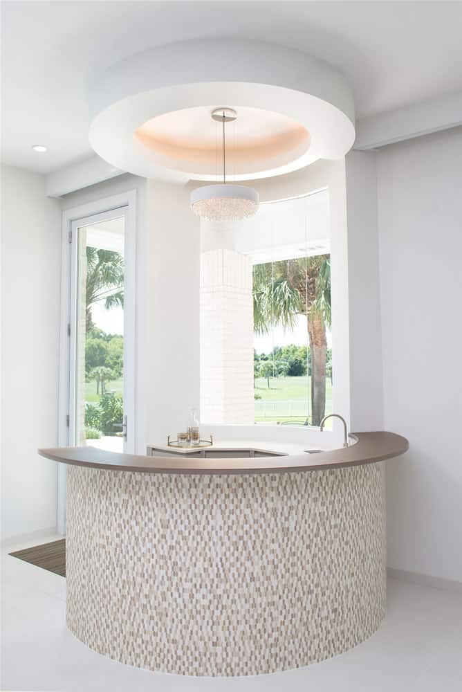 stone mosaic clad circular bar makes just the right touch of elegance in a space perfect to entertain in