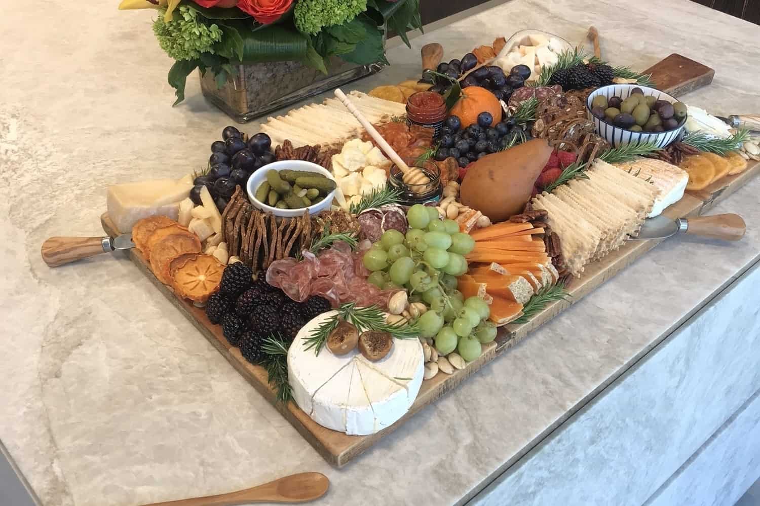 Los Angeles-based food stylist, Meg Quinn, presented this rectangular cheese and fruit tray with circular features to create an artistic display