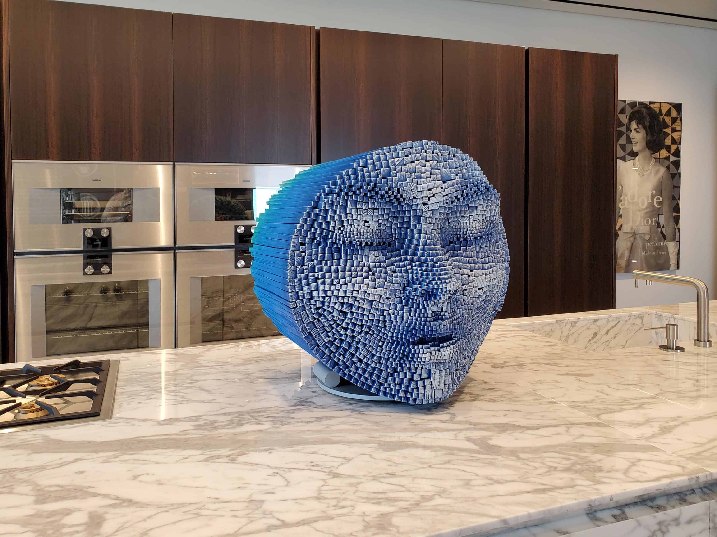 curated art exhibition at eggersmann dallas featured this blue moon head sculpture by robert mars