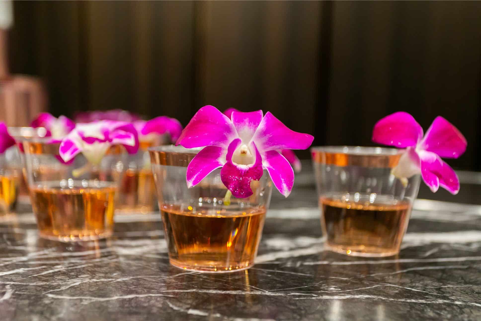 rose cocktails with orchid garnish served to guest in the eggersmann kitchens chicago showroom during the rndd gallery walk 2019