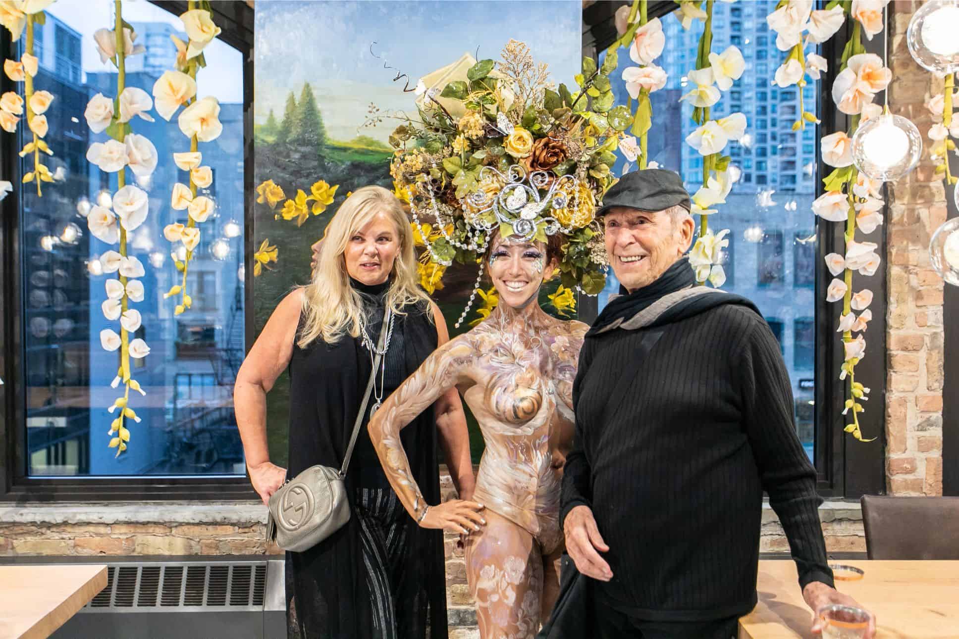 a couple posing with the living statue at the rndd gallery walk 2019 in the eggersmann kitchens chicago showroom