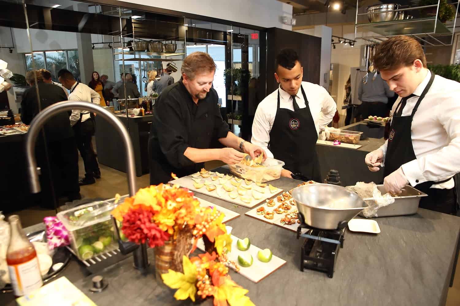 chef mark and staff of dine catering of houston prepare hors douerves for guests of the aia houston home tour appreciation party