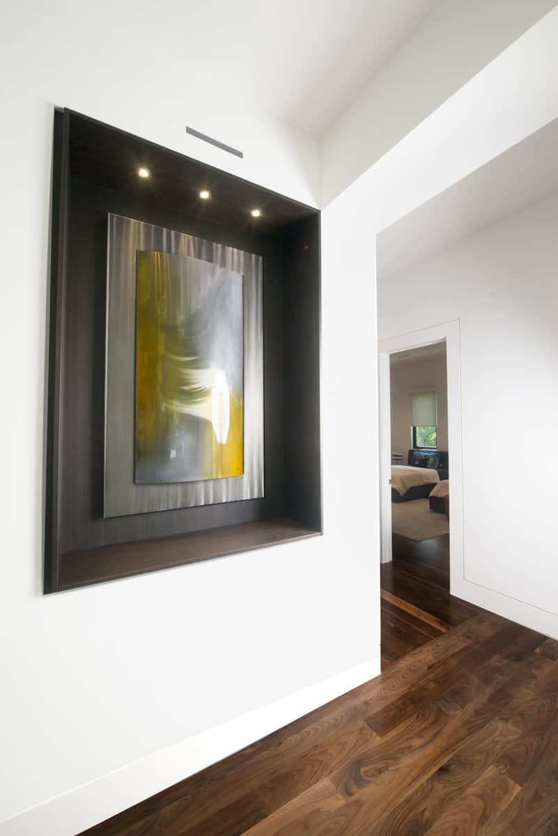 lighted art niche designed by eggersmann sets off the homeowners' art collection