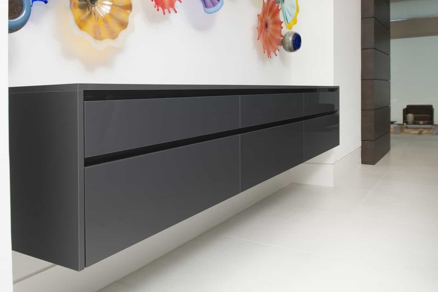 floating credenza designed by eggersmann offers ample storage in the dining room of this contemporary home