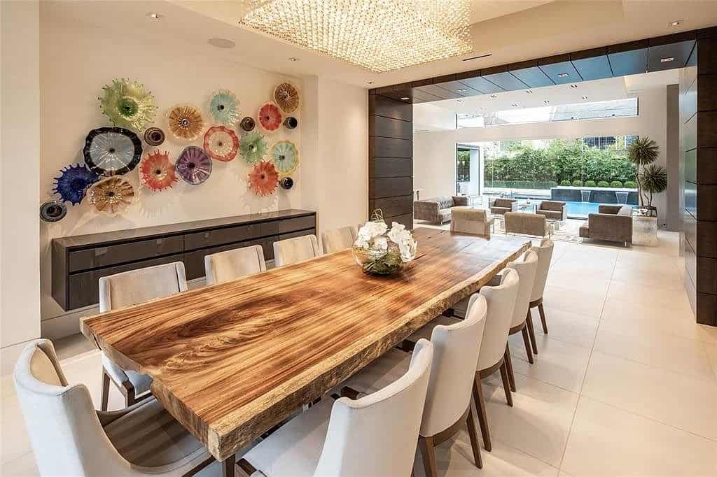 dining room with oversized rough hewn natural edge plank table and eggersmann floating credenze