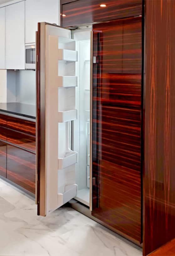 subzero fridge freezer combo integrated into maccassar ebony cabinetry with high gloss lacquer finish