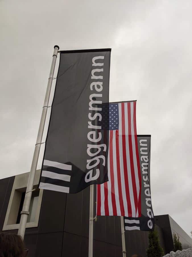eggersmann factory tour flags in front of factory include eggersmann logo and us flag