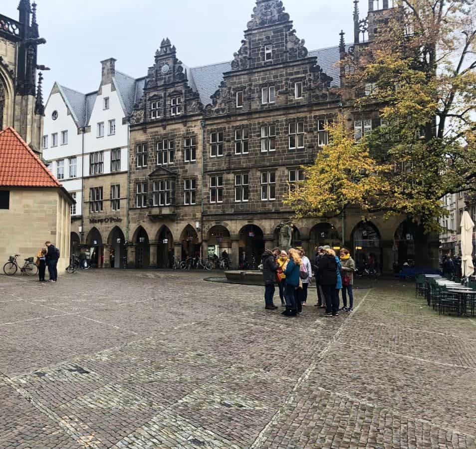plaza surrounded by baroque architecture in muenster germany