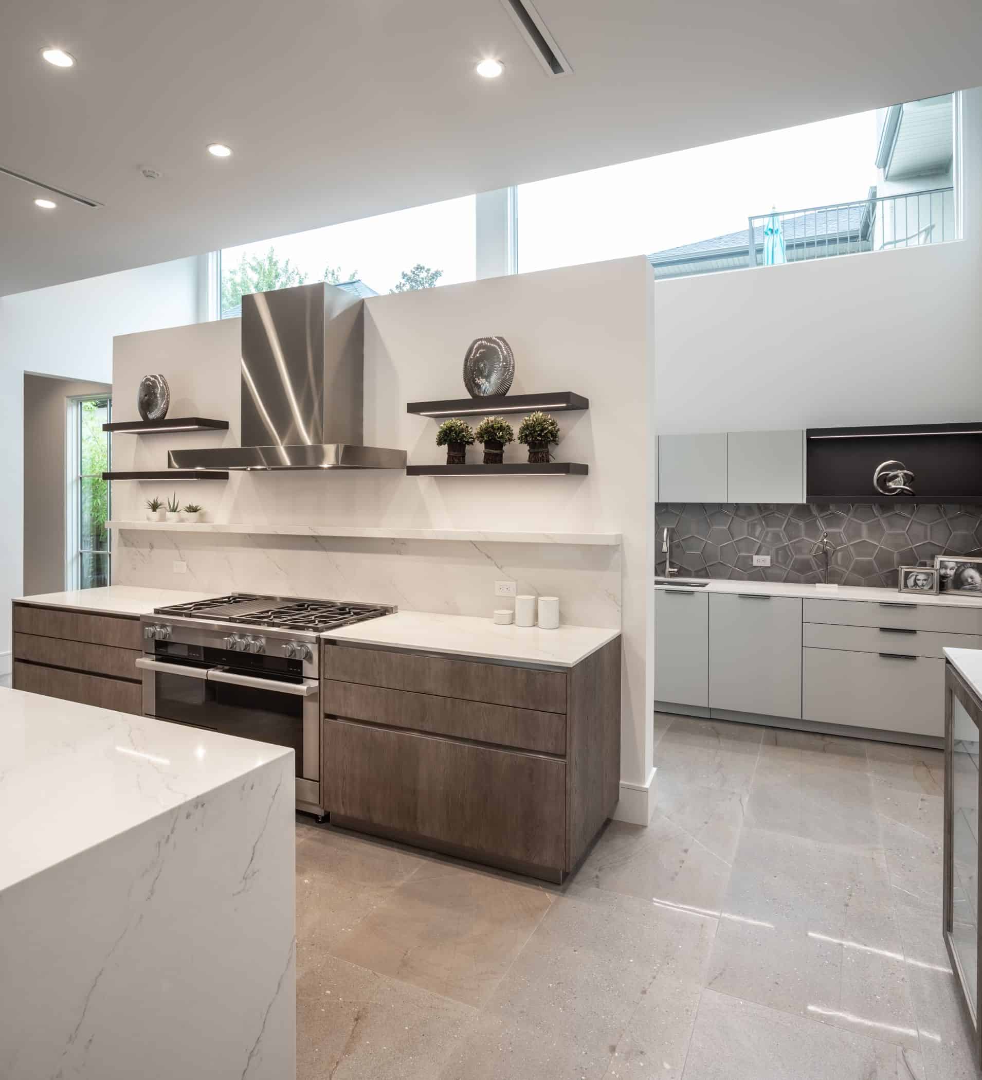 floating wall with stove and display shelves that hides the catering kitchen of a washington coalition memorial park area home in houston renovated by chavez