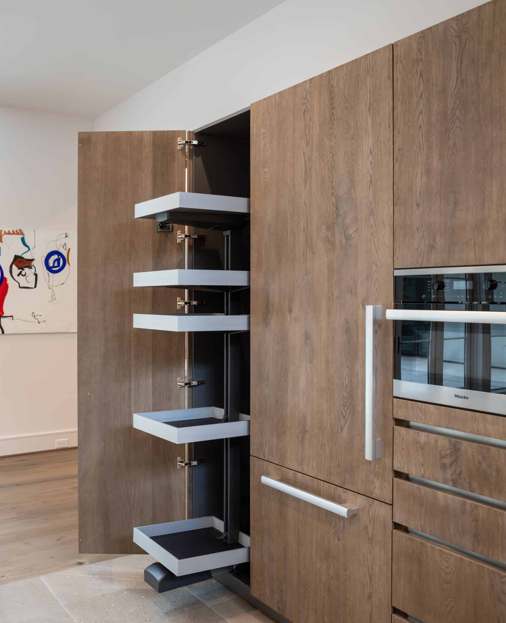 hidden storage in custom german cabinetry in a washington coalition memorial park area home in houston