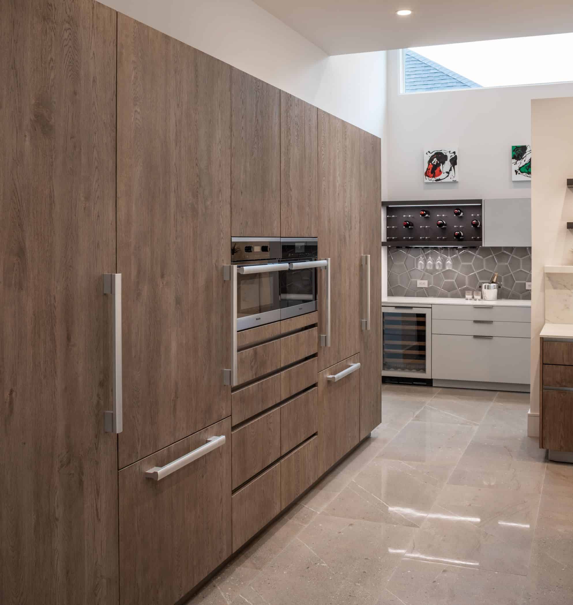 integrated appliance wall and hidden pantry in german cabinetry of a washington coalition memorial park area home in houston